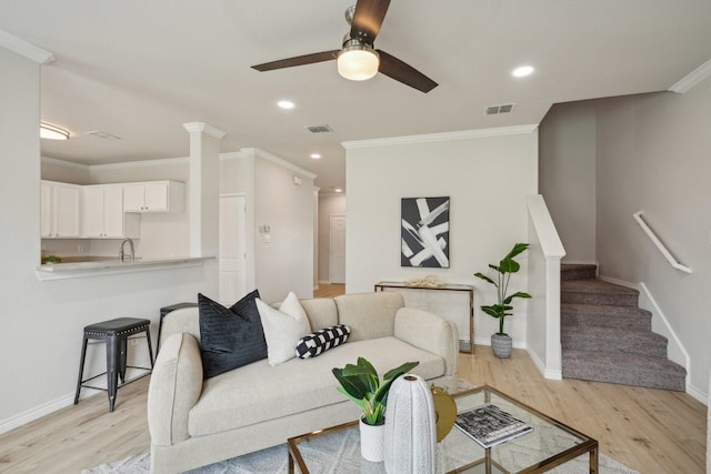 12350 Orloff Dr, Rhome, TX 76078 - living area with light wood-style flooring, stairway, baseboards, crown molding, and ceiling fan