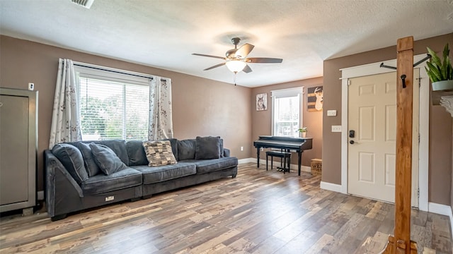 8147 Fawn Cir, Granbury, TX 76049 - living area with a ceiling fan, light wood-style flooring, baseboards, and a textured ceiling