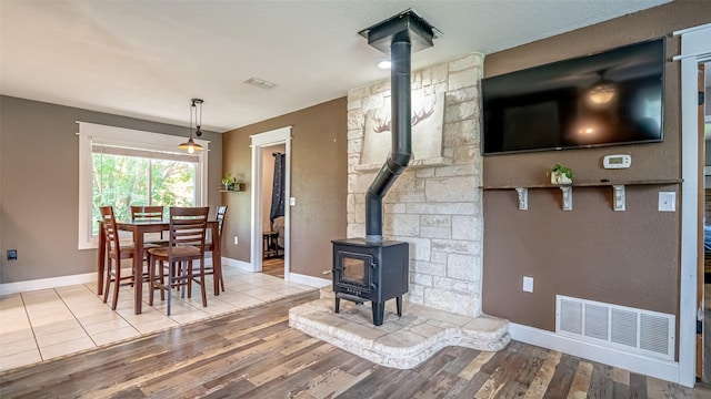 8147 Fawn Cir, Granbury, TX 76049 - dining space with a wood stove, baseboards, and wood finished floors