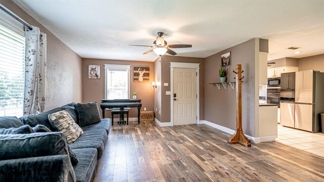 8147 Fawn Cir, Granbury, TX 76049 - living area featuring light wood-type flooring, a ceiling fan, and baseboards
