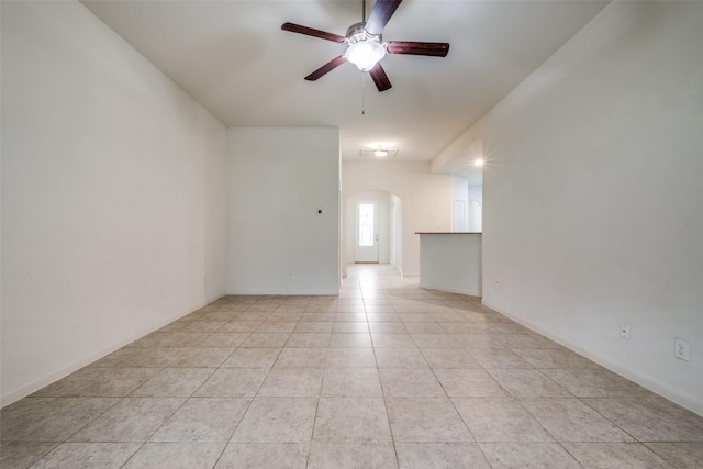 4601 Shy Creek Ln, Denton, TX 76207 - spare room with arched walkways, ceiling fan, and light tile patterned floors