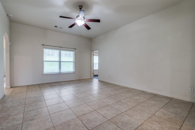 4601 Shy Creek Ln, Denton, TX 76207 - tiled empty room featuring a ceiling fan and arched walkways