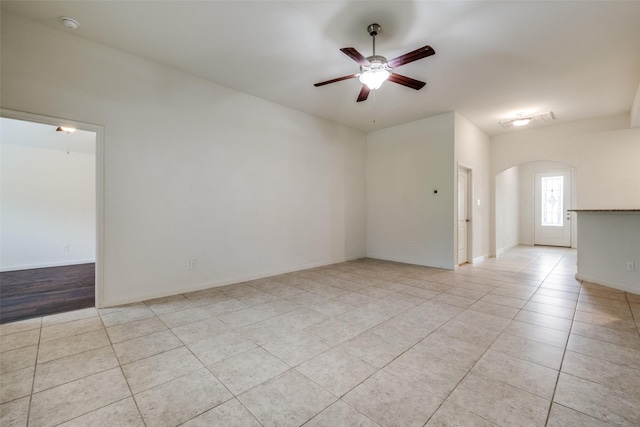 4601 Shy Creek Ln, Denton, TX 76207 - unfurnished room with arched walkways, a ceiling fan, light tile patterned floors, and a smoke detector
