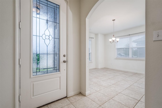 4601 Shy Creek Ln, Denton, TX 76207 - entryway featuring a chandelier, light tile patterned floors, and arched walkways