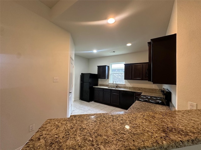 4601 Shy Creek Ln, Denton, TX 76207 - kitchen with a sink, black appliances, light tile patterned floors, recessed lighting, and stone countertops