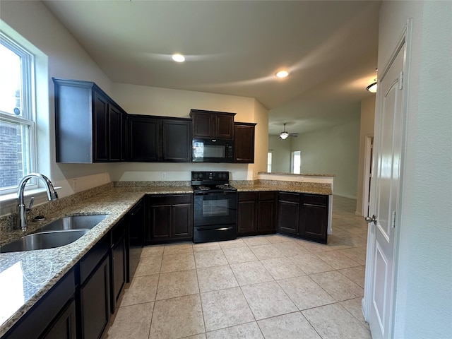 4601 Shy Creek Ln, Denton, TX 76207 - kitchen featuring black appliances, a sink, light stone countertops, a peninsula, and light tile patterned flooring