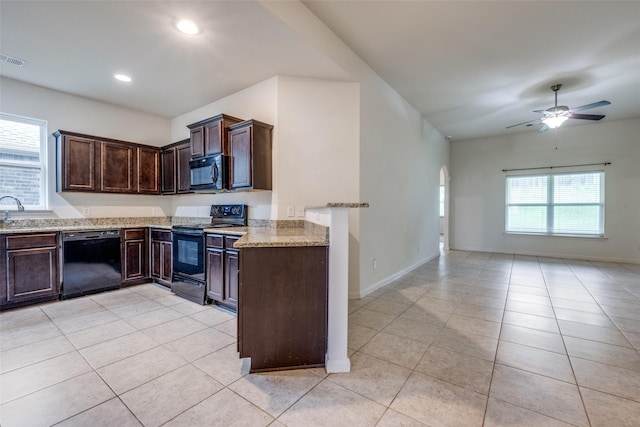 4601 Shy Creek Ln, Denton, TX 76207 - kitchen with black appliances, light tile patterned flooring, light stone counters, ceiling fan, and recessed lighting