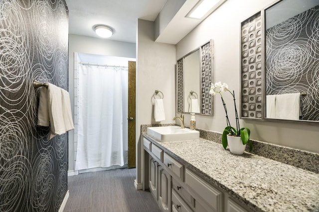 full bath featuring vanity and wood finished floors