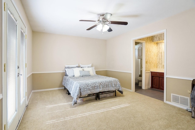 bedroom featuring connected bathroom, carpet, baseboards, and ceiling fan