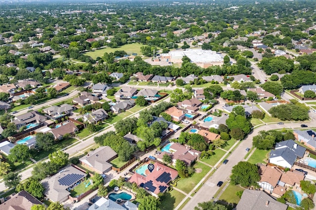 aerial view of property and surrounding area featuring nearby suburban area