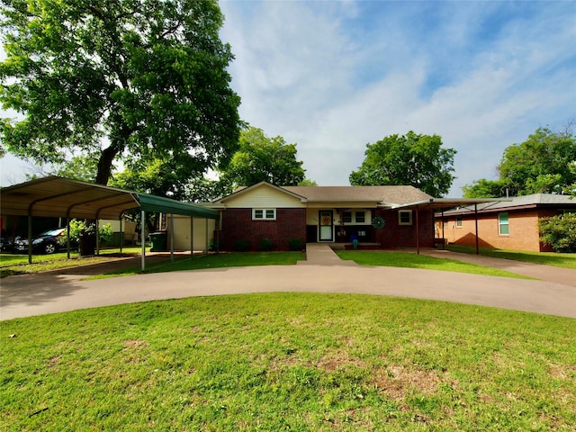 804 Austin Rd, Graham, TX 76450 - ranch-style house featuring curved driveway, a front lawn, a detached carport, and brick siding