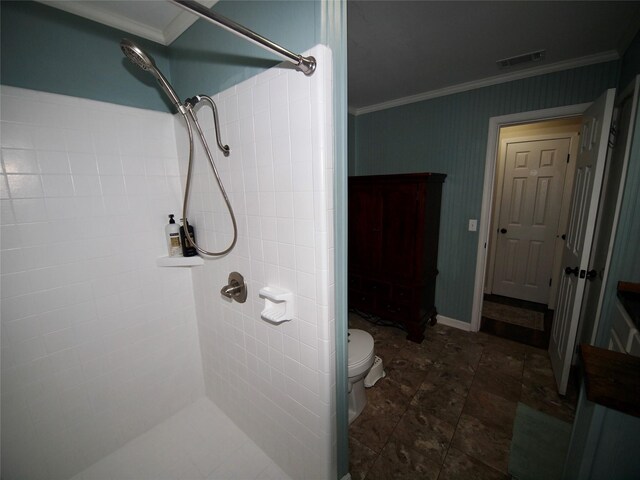 804 Austin Rd, Graham, TX 76450 - bathroom with tiled shower, ornamental molding, and toilet