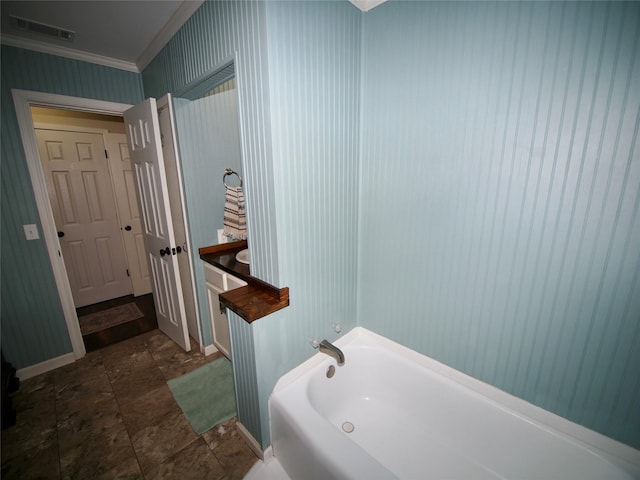 804 Austin Rd, Graham, TX 76450 - bathroom featuring ornamental molding, a bath, baseboards, and stone finish flooring