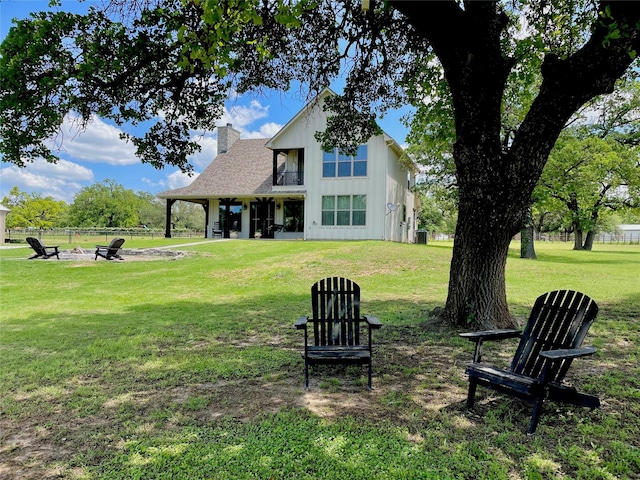 1299 Harmony Cir, Weatherford, TX 76087 - back of house featuring a fire pit and a chimney