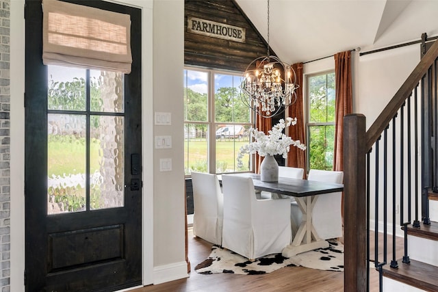 1299 Harmony Cir, Weatherford, TX 76087 - foyer entrance featuring a chandelier, wood finished floors, healthy amount of natural light, and vaulted ceiling