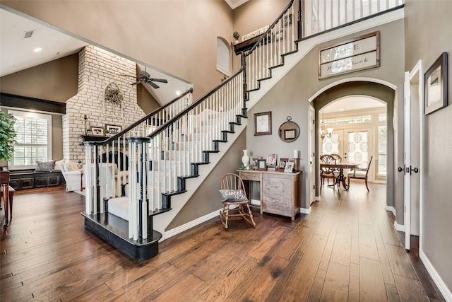 3325 Creek Rd, Keller, TX 76248 - stairs featuring arched walkways, high vaulted ceiling, a ceiling fan, wood-type flooring, and baseboards