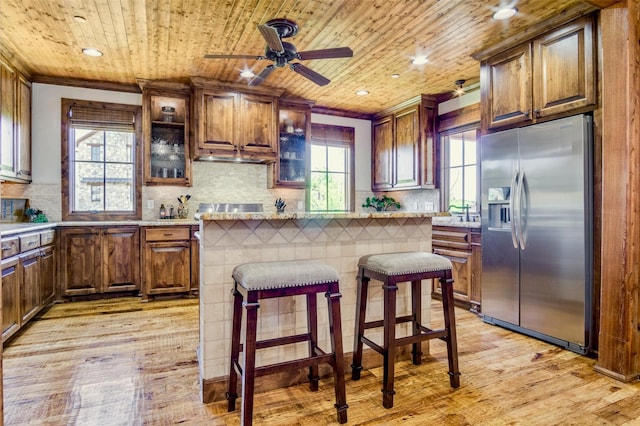 1633 Scenic Dr Unit 201, Graford, TX 76449 - kitchen with stainless steel fridge with ice dispenser, wood ceiling, light wood finished floors, tasteful backsplash, and ceiling fan