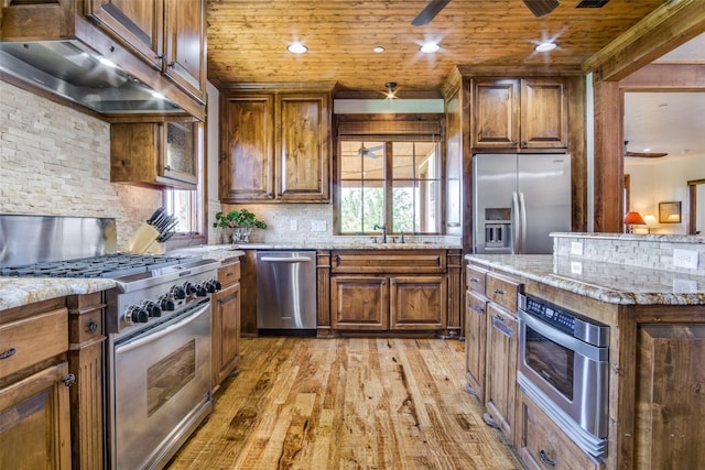 1633 Scenic Dr Unit 201, Graford, TX 76449 - kitchen featuring appliances with stainless steel finishes, exhaust hood, light wood-style floors, healthy amount of natural light, and wood ceiling
