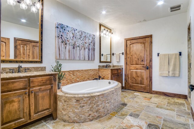 1633 Scenic Dr Unit 201, Graford, TX 76449 - full bath featuring a bath, stone tile floors, and two vanities