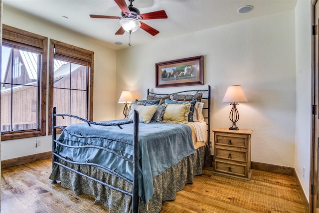 1633 Scenic Dr Unit 201, Graford, TX 76449 - bedroom with wood finished floors, baseboards, and ceiling fan