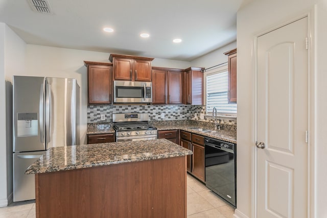 3001 Rocking Hills Trl, Forney, TX 75126 - kitchen featuring stainless steel appliances, light tile patterned flooring, a kitchen island, dark stone counters, and a sink
