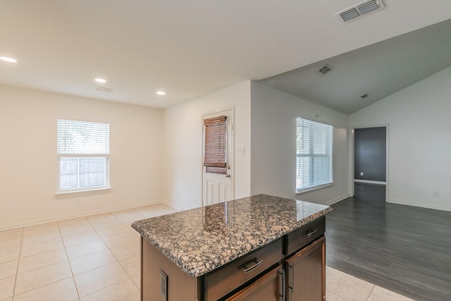 3001 Rocking Hills Trl, Forney, TX 75126 - kitchen with open floor plan, light tile patterned flooring, dark stone countertops, recessed lighting, and a center island