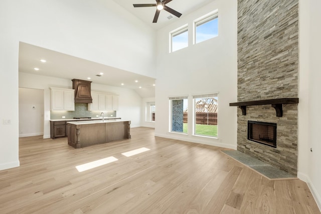 1024 Emerald Trace Dr, Justin, TX 76247 - kitchen with open floor plan, custom range hood, ceiling fan, a center island with sink, and a sink