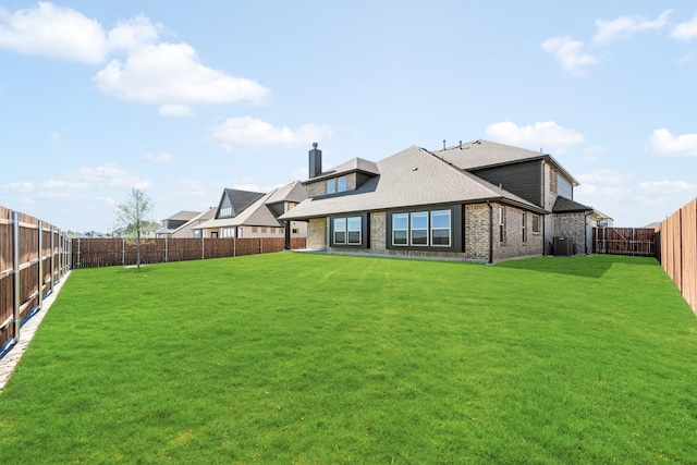 1024 Emerald Trace Dr, Justin, TX 76247 - rear view of house featuring brick siding, central AC, a shingled roof, and a chimney