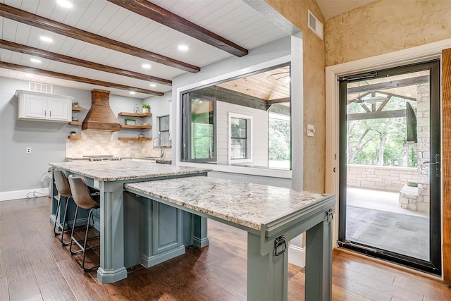 132 S Briaroaks Rd, Burleson, TX 76028 - kitchen featuring open shelves, tasteful backsplash, dark wood-style flooring, beamed ceiling, and a breakfast bar area