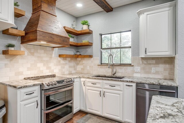 132 S Briaroaks Rd, Burleson, TX 76028 - kitchen with open shelves, appliances with stainless steel finishes, a sink, custom exhaust hood, and white cabinetry