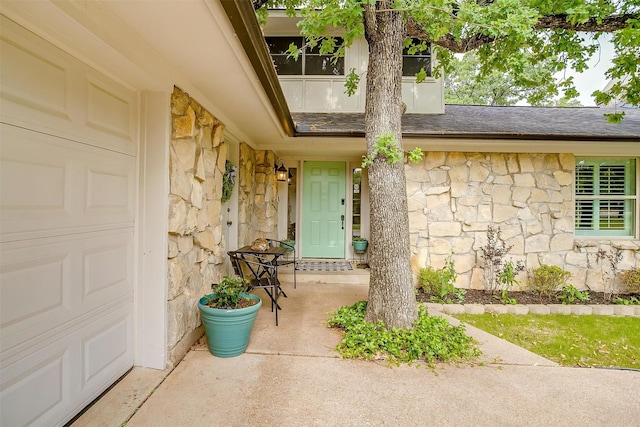 132 S Briaroaks Rd, Burleson, TX 76028 - property entrance featuring stone siding and roof with shingles