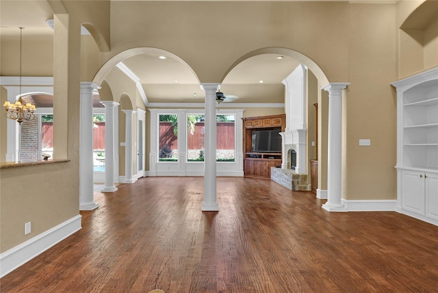 6805 Castle Pines Ct, Tyler, TX 75703 - unfurnished living room featuring a fireplace with raised hearth, crown molding, dark wood-style floors, baseboards, and recessed lighting