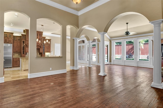 6805 Castle Pines Ct, Tyler, TX 75703 - unfurnished living room with ornate columns, a ceiling fan, ornamental molding, light wood finished floors, and baseboards