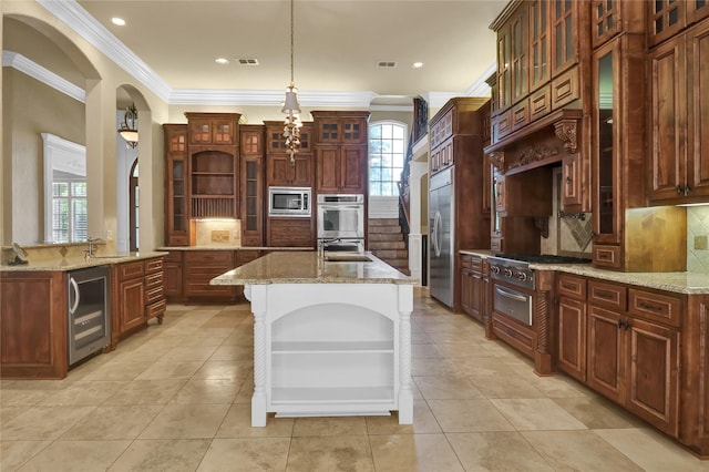 6805 Castle Pines Ct, Tyler, TX 75703 - kitchen featuring wine cooler, built in appliances, a warming drawer, crown molding, and a kitchen island with sink