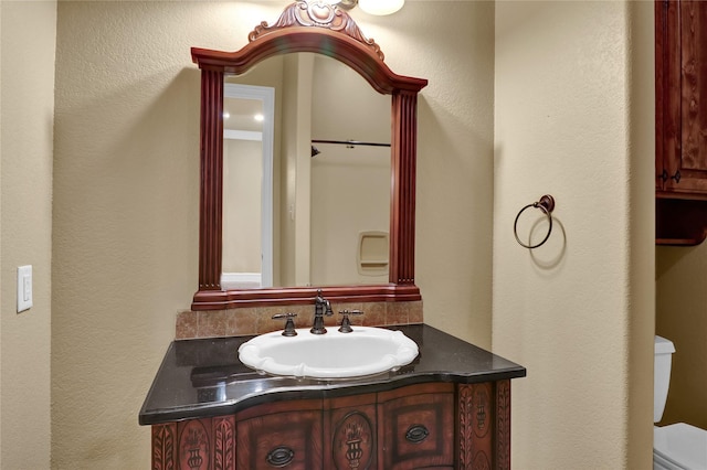 6805 Castle Pines Ct, Tyler, TX 75703 - bathroom with a textured wall, toilet, and vanity
