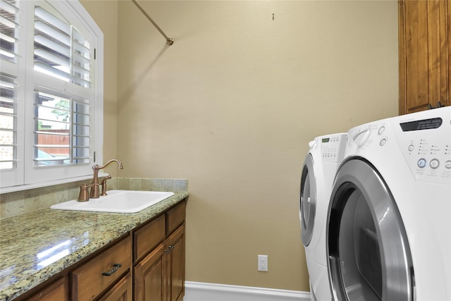 6805 Castle Pines Ct, Tyler, TX 75703 - clothes washing area with washer and clothes dryer and cabinet space