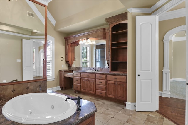 6805 Castle Pines Ct, Tyler, TX 75703 - bathroom with a jetted tub, vanity, ornamental molding, tile patterned floors, and decorative columns