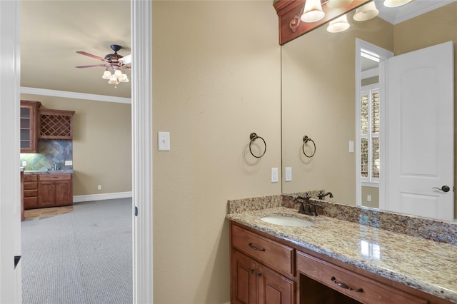 6805 Castle Pines Ct, Tyler, TX 75703 - bathroom featuring ceiling fan, ornamental molding, vanity, and baseboards