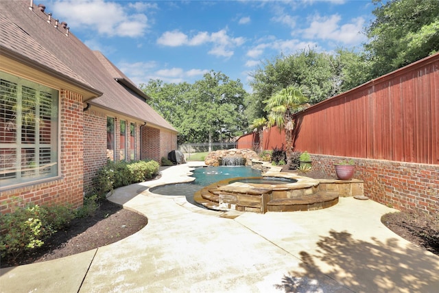 6805 Castle Pines Ct, Tyler, TX 75703 - view of patio / terrace with an in-ground hot tub and a fenced backyard
