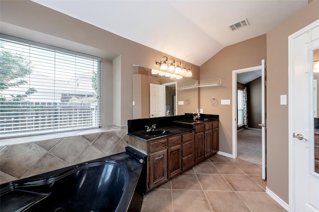 112 Glen Ridge Dr, Murphy, TX 75094 - full bathroom with lofted ceiling, tile patterned flooring, double vanity, a jetted tub, and baseboards