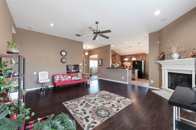 112 Glen Ridge Dr, Murphy, TX 75094 - living room featuring wood finished floors, a ceiling fan, a chandelier, a glass covered fireplace, and recessed lighting
