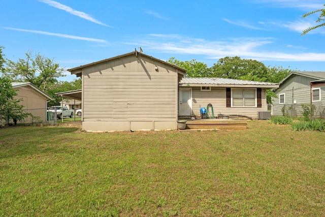 685 S First Ave, Stephenville, TX 76401 - rear view of house with a lawn, cooling unit, and metal roof