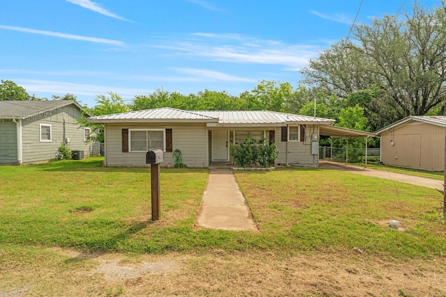 685 S First Ave, Stephenville, TX 76401 - view of front of house with a front yard, concrete driveway, an attached carport, metal roof, and central air condition unit