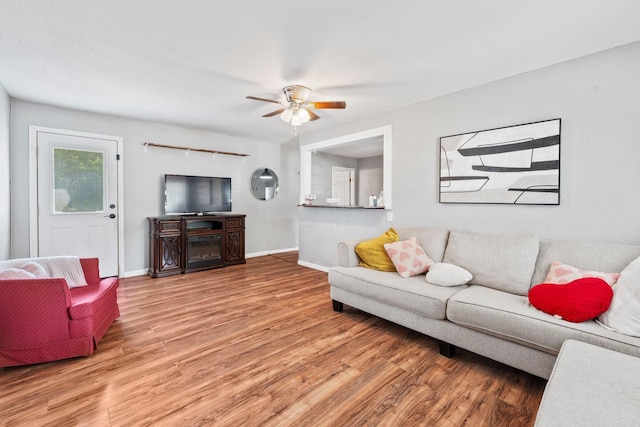 685 S First Ave, Stephenville, TX 76401 - living room featuring wood finished floors, a ceiling fan, and baseboards