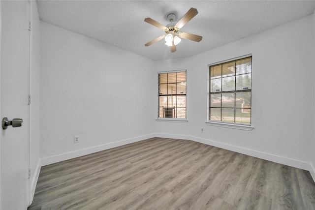 1204 Oak Park Dr, Dallas, TX 75232 - unfurnished room with a textured ceiling, a ceiling fan, light wood-type flooring, and baseboards