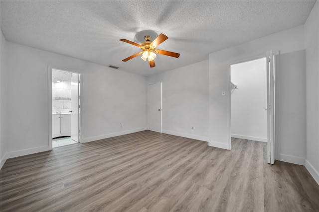 1204 Oak Park Dr, Dallas, TX 75232 - spare room with ceiling fan, wood finished floors, a textured ceiling, and baseboards