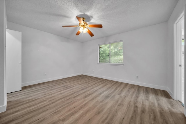 1204 Oak Park Dr, Dallas, TX 75232 - spare room with ceiling fan, wood finished floors, a textured ceiling, and baseboards