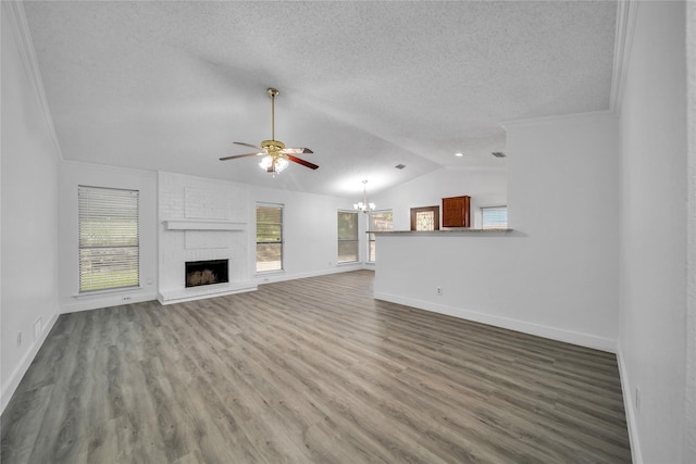 1204 Oak Park Dr, Dallas, TX 75232 - unfurnished living room featuring a chandelier, lofted ceiling, ceiling fan, a textured ceiling, and baseboards