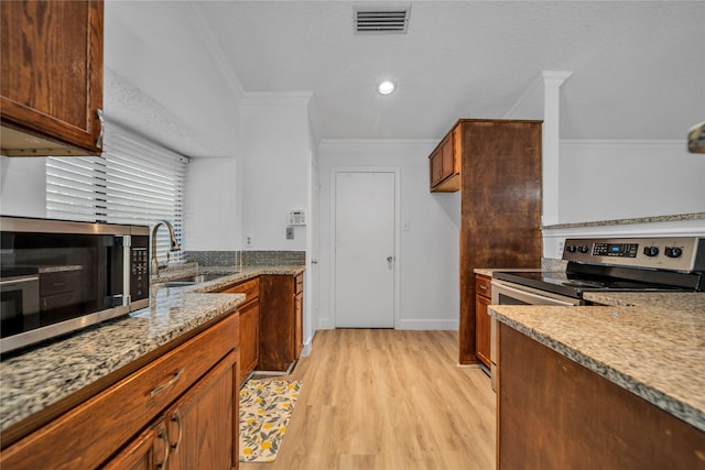1204 Oak Park Dr, Dallas, TX 75232 - kitchen with a sink, stainless steel appliances, crown molding, light wood finished floors, and light stone counters