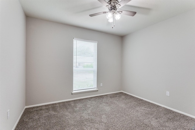 empty room featuring carpet flooring, ceiling fan, and baseboards
